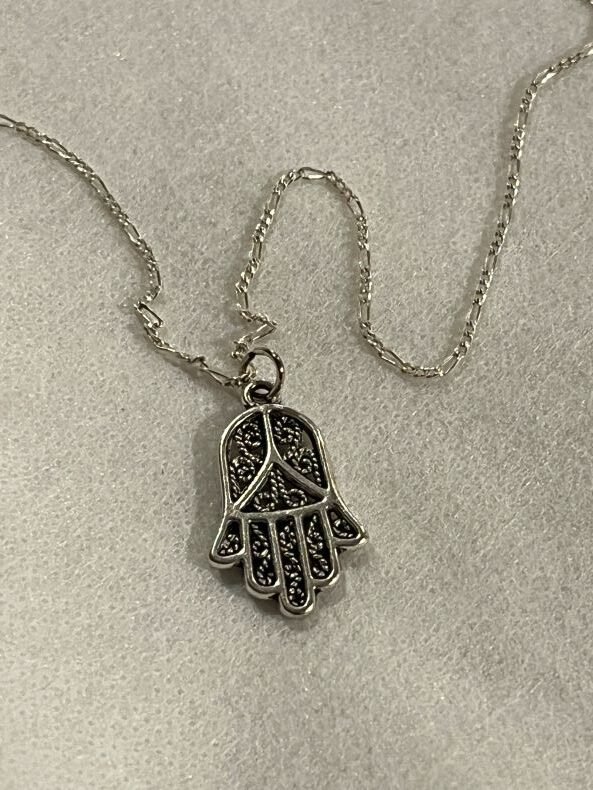 silver Hamsa necklace features a stunning filigree pattern