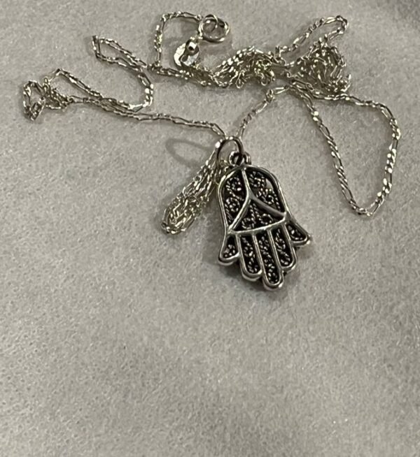 The pendant is Hamsa hand. Hamsa hand holds cultural significance in many traditions