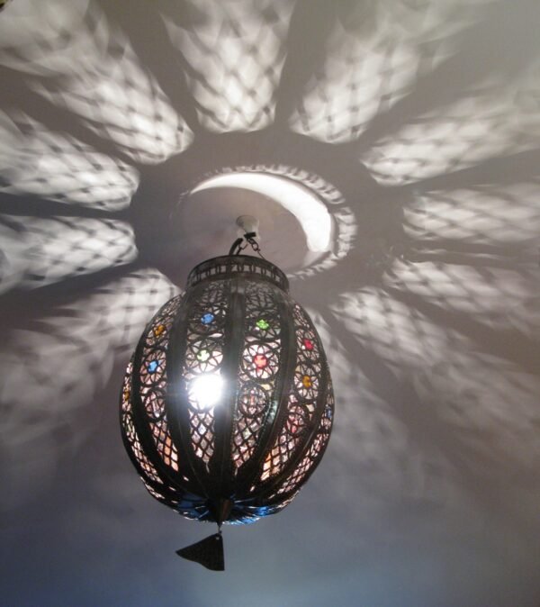 Moroccan Pendant lights featuring metalwork and colored glass, casting captivating patterns when lit