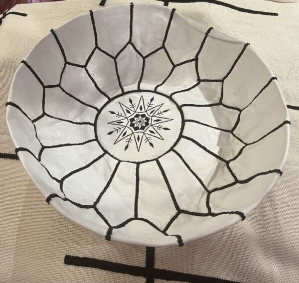 White pouf with black stitching