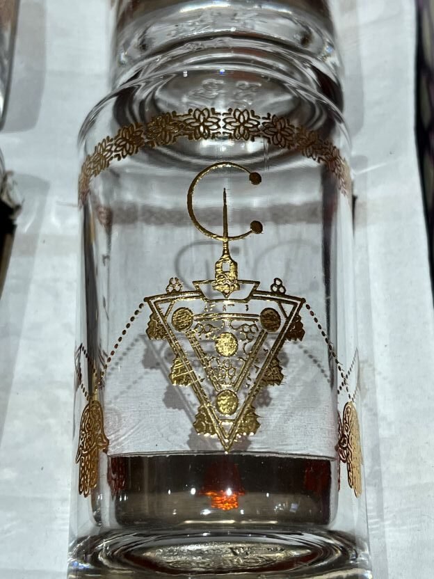 gold berber fibula on tea glasses design