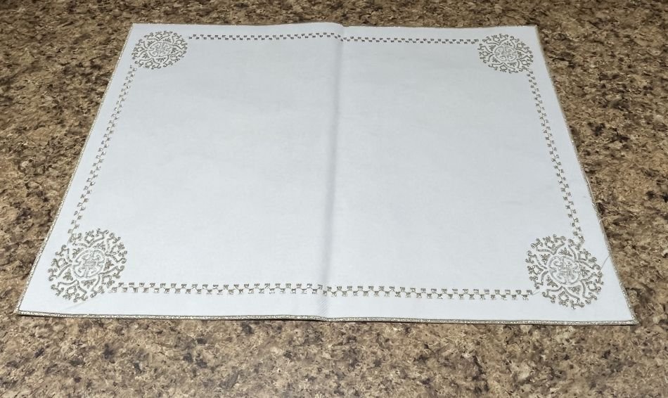 Cette nappe est pour votre plateau. fait en simili cuir, elle est ornée de broderies dorées.