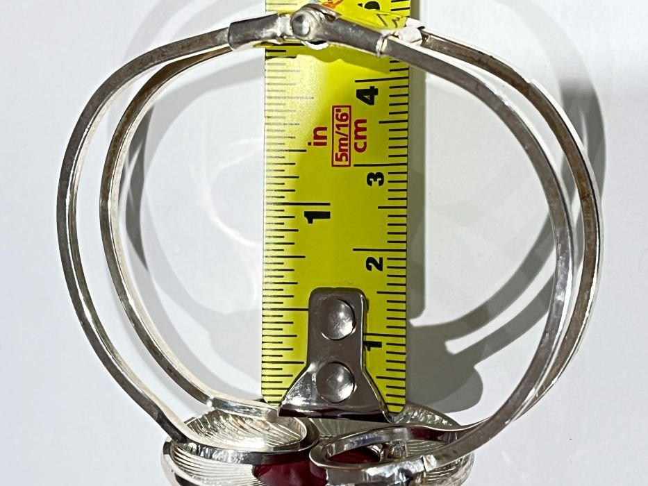 Designed with a structured double-band silhouette and secure clasp