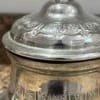vintage-silver- teapot-top Heat water and steep a mix of green tea, fresh mint, and sugar in the teapot.