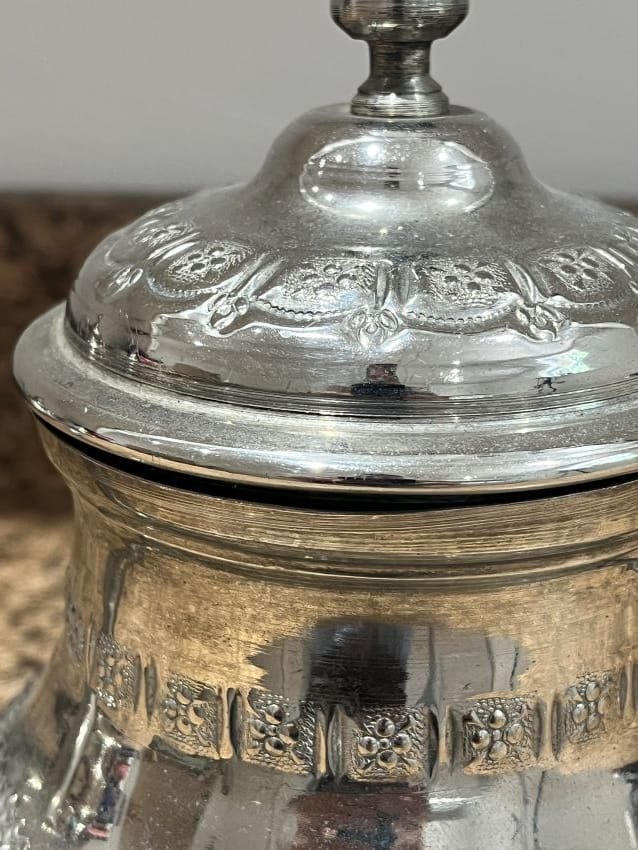 vintage-silver- teapot-top Heat water and steep a mix of green tea, fresh mint, and sugar in the teapot.